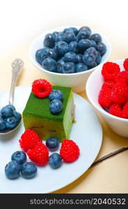 green tea matcha mousse cake with raspberries and blueberries on top