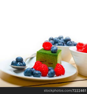 green tea matcha mousse cake with raspberries and blueberries on top