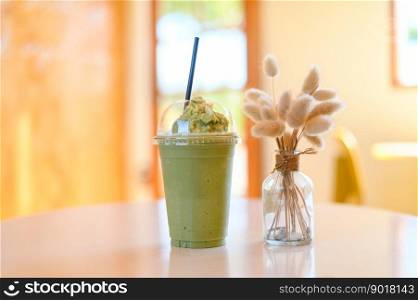 green tea smoothie plastic cup on wooden table, a cup green tea in cafe