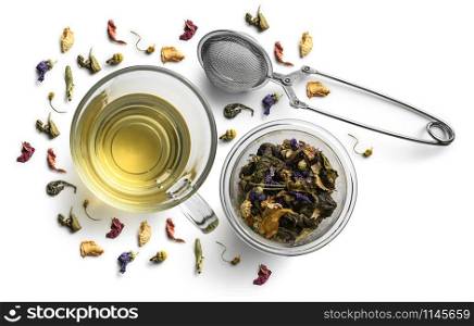 Green tea with natural flavors and a cup. Top view on white background.. Green tea with natural flavors and a cup. Top view on white background