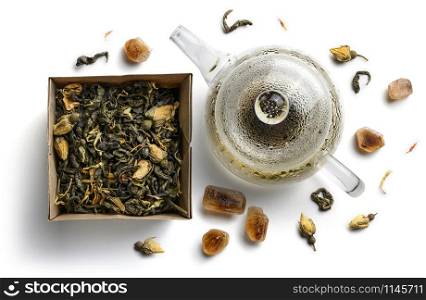 Green tea with natural flavors and a teapot. Top view on white background.. Green tea with natural flavors and a teapot. Top view on white background