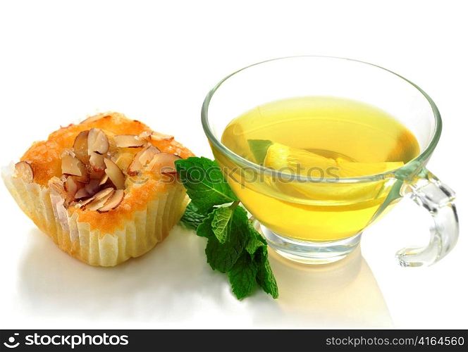 green tea with raspberry cupcake with almonds , close up