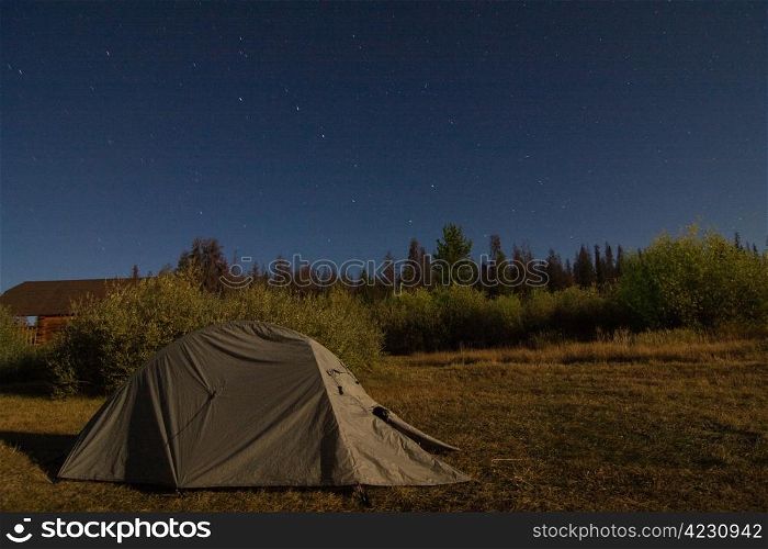 Green tent at night under the stars