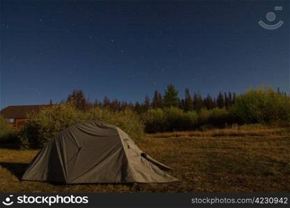 Green tent at night under the stars