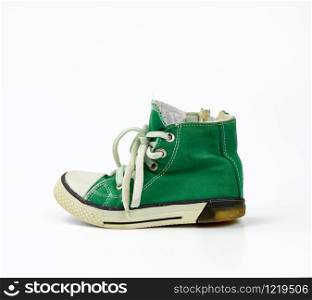 green textile sneaker with white tied shoelaces on a white background, shoes are sideways