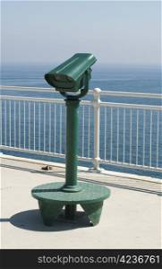 Green tourist telescope. Sea view and sky