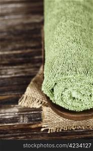 Green towel over wooden surface