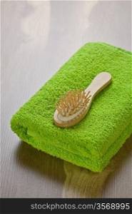 green towel with hairbrush