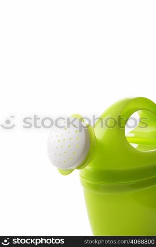 Green toy watering can on white