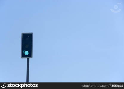 Green Traffic Light Against A Blue Sky