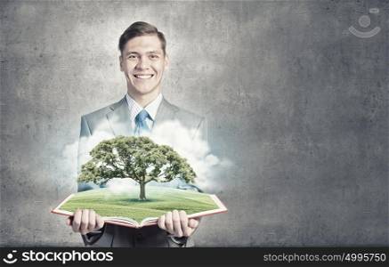 Green tree. Businessman open book with growing tree concept