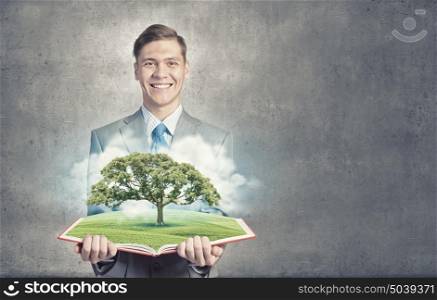 Green tree. Businessman open book with growing tree concept