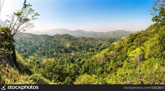 Green tropical mountains in a valley on Ceylon. Landscape of Sri Lanka. Green tropical forest in a valley on Ceylon
