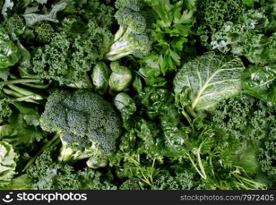 Green vegetables and dark leafy food background as a healthy eating concept of fresh garden produce organically grown as a symbol of health as kale swiss chard spinach collards broccoli and cabbage.