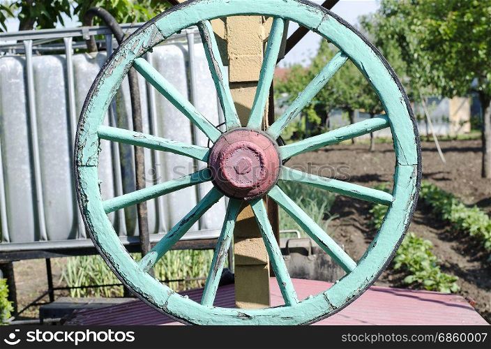 Green wooden cart wheel