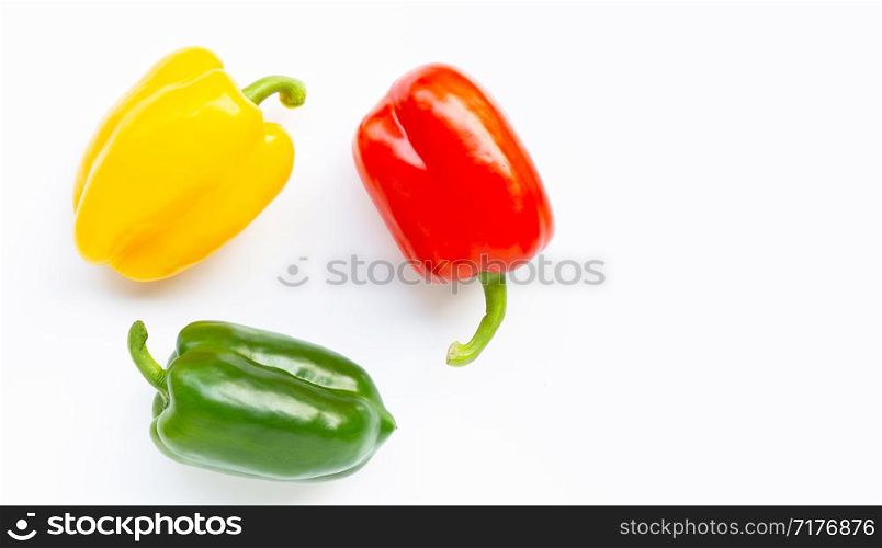 Green, yellow and red fresh bell pepper on white background.