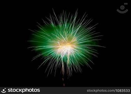 Green Yellow Sparkling Fireworks Background on Night Scene. Abstract color fireworks background and smoke on sky