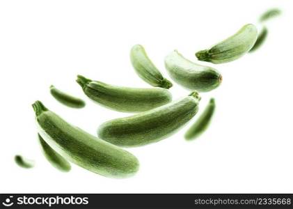 Green zucchini levitate on a white background.. Green zucchini levitate on a white background