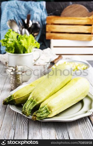 green zucchini on dark background. Healthy food, green vegan diet.