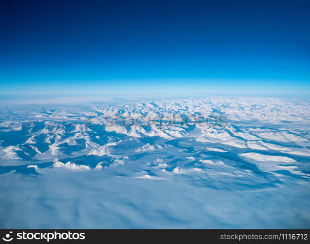 Greenland frozen landscape aerial view shot from plane. Complex Snow Mountains Stunning valley and glacier