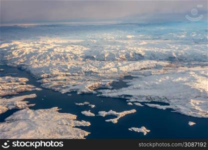 Greenlandic ice cap with frozen mountains and fjord aerial view, near Nuuk, Greenland