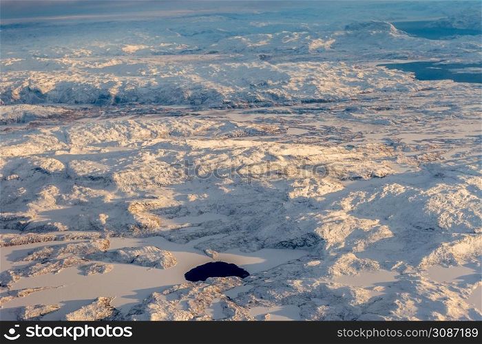 Greenlandic ice cap with frozen mountains and lake aerial view, near Nuuk, Greenland
