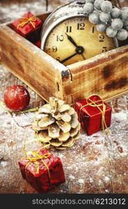 Greeting card for Christmas. Vintage box with an old-fashioned clock alarm clock and Christmas decorations