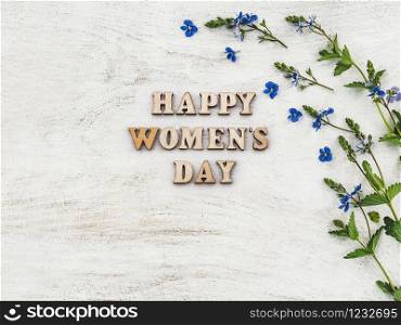 Greeting card for Women&rsquo;s Day. Beautiful, vibrant flowers lying on a white boards. View from above, close-up. Beautiful flowers lying on a white table