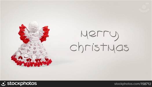 Greeting card with merry christmas writing with crochet angel