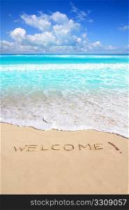 greetings welcome beach spell written on sand Caribbean tropical sea