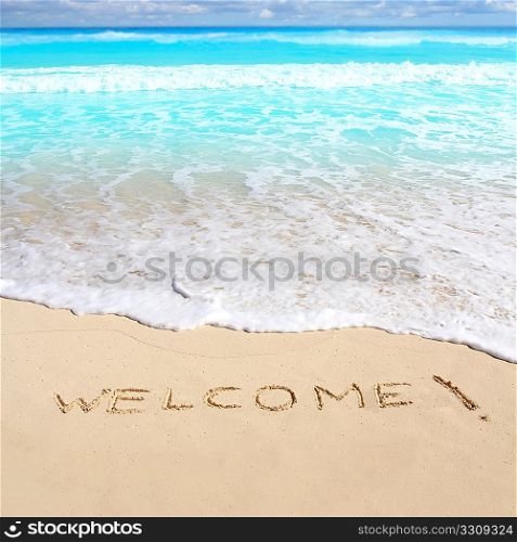 greetings welcome beach spell written on sand Caribbean tropical sea