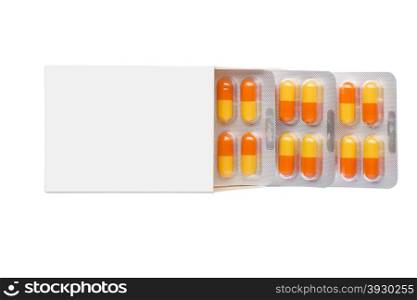 Grey box with orange pills in a blister pack on an isolated background. Grey box with orange pills in a blister pack