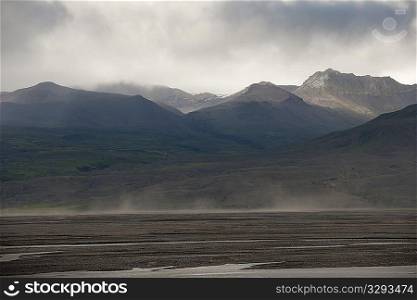 Grey cloud landscape of mountain range and meadow