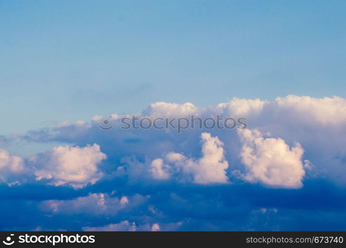 Grey color clouds partly cover the sky in the daytime