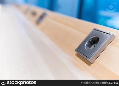 grey electrical socket on brown wood boards. electrical outlet