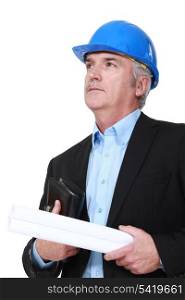 Grey-haired architect holding plans and agenda