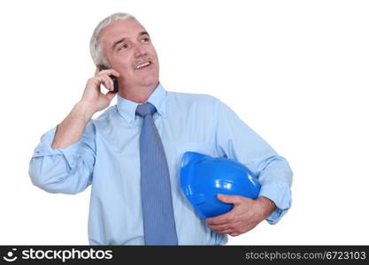 Grey-haired architect making call