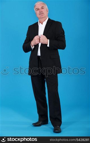 Grey-haired businessman posing