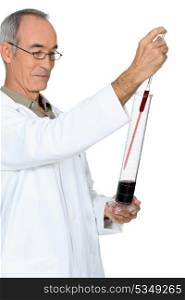 Grey haired man testing wine