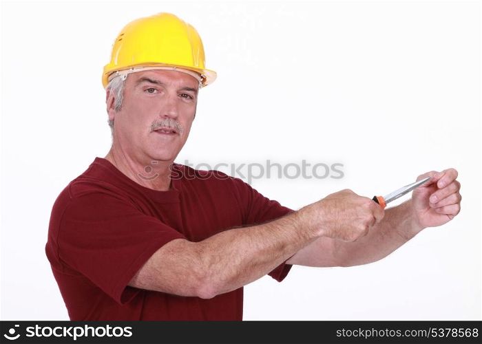 Grey haired man using screw driver
