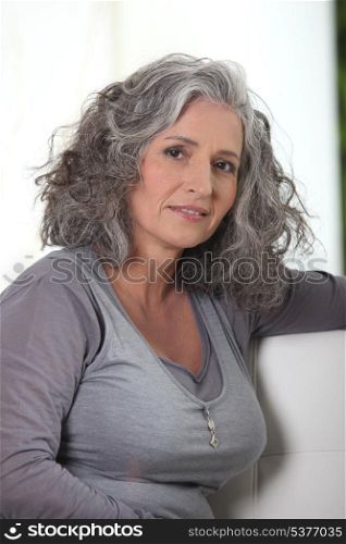 Grey-haired retired woman has a lot of free time