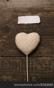 grey heart tissue on a dark wooden background. Valentine&#39;s day.
