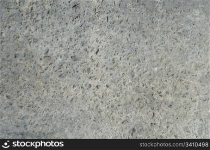 Grey industrial concrete texture with small stones.