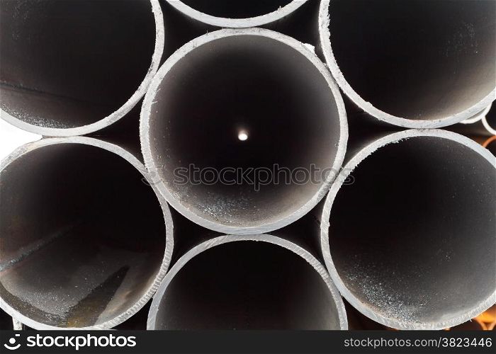 grey metal pipes close up on outdoor warehouse in winter