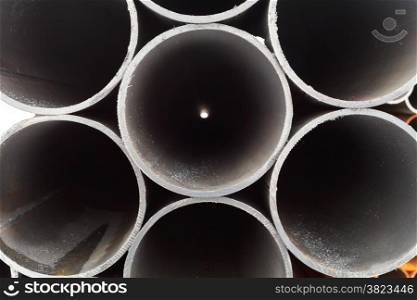 grey metal pipes close up on outdoor warehouse in winter