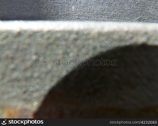 grey metal surface with a dark shadow