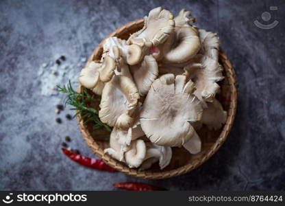 Grey oyster mushroom on basket , fresh raw oyster mushroom with herbs and spices for cooking food