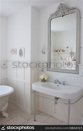 Grey painted mirror surround in panelled bathroom London