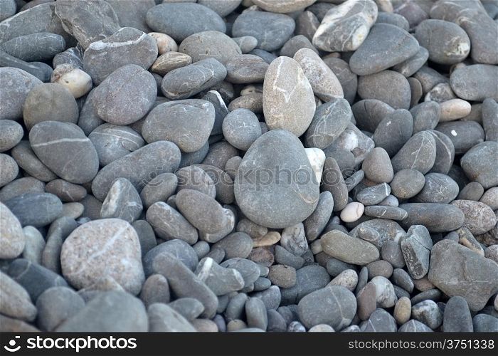 Grey pebbles on the beach at background