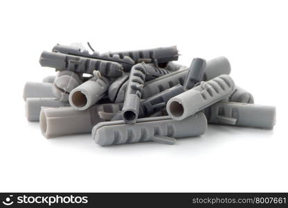 Grey plastic dowels isolated on white background.